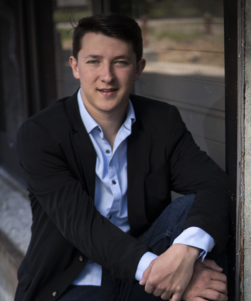 Justin O'Bryan sitting on a window ledge